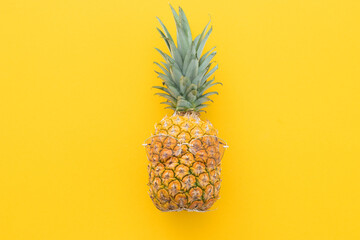 Hipster pineapple with sunglasses against a yellow background