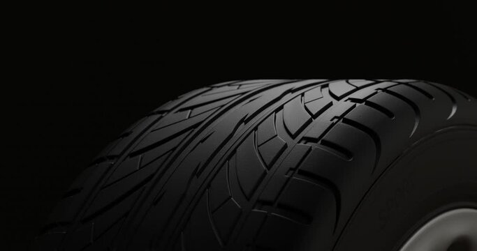4K Animation. Car rim rotate. Close up perspective view on a black background car tire in motion. Wheel rotate cyclic. 3d Render