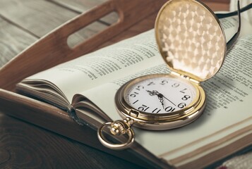 Beautiful old clock, old book on the desk