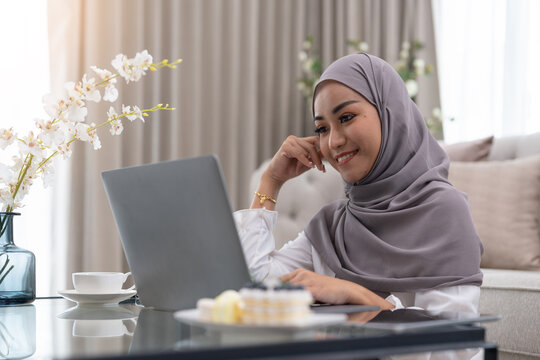 Muslim Young Women Wear Hijab Using Computer Laptop At Home Morning. Concept Business Small And Shop Online