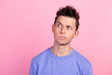 Photo of thoughtful handsome young man think look empty space dream isolated on pastel color...