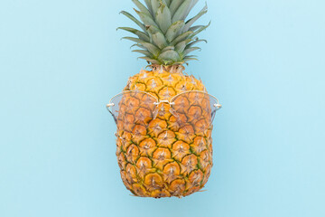 Hipster pineapple with sunglasses against a blue background