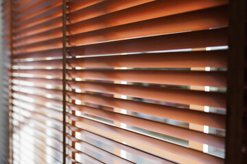 Wooden shutters blind with soft focus. light and shadow on  blind curtain decorate in office.