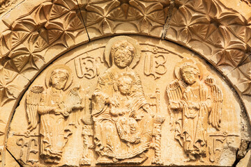 Fototapeta na wymiar Stone carvings on the facade of Surb Astvatsatsin church in Noravank, Armenia