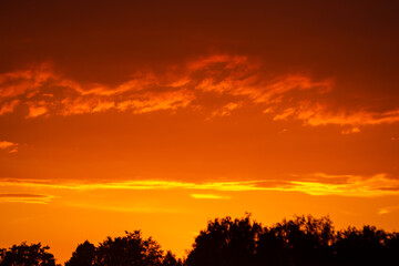 Fototapeta na wymiar Orange and yellow clouds at sunset