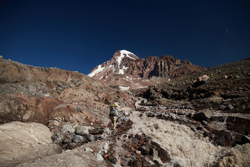 Gergeti glacier waterfall. Nature of Caucasian mountains. Road to the base camp in Kazbek, Georgia. Mount Kazbek alpinist expedition