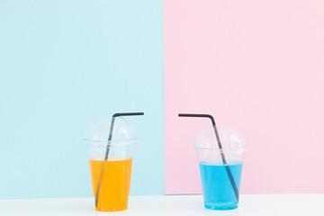 Fresh lemonade cocktail on color background. Cocktail in plastic cup