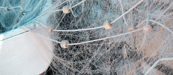 fishing net with float line or fish nets with small plastic floats on wooden fisherman boat,...