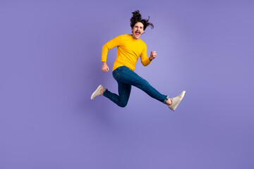 Fototapeta na wymiar Full size portrait of excited satisfied person jumping have fun good mood isolated on purple color background