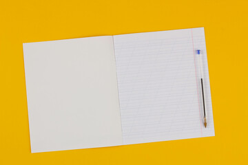 School notebook on a yellow background with copy space for text and transparent pen. Back to...