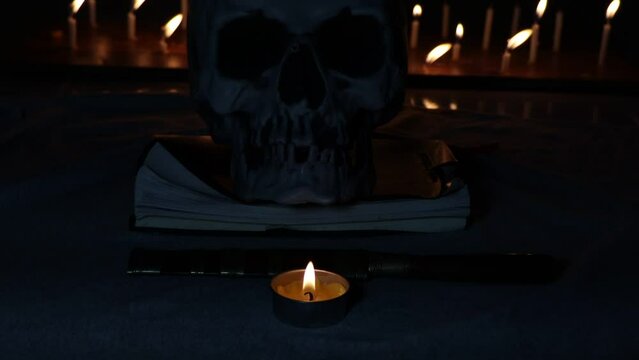 curse doll in hand and skull background, religion and belief