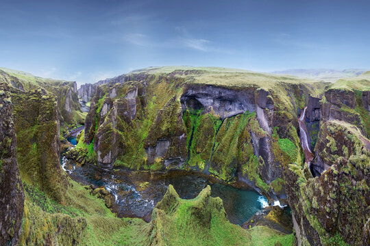 The illusion of beautiful canyon Fardrargljufur in Iceland. Canyon with green flora and blue water in tranquility.