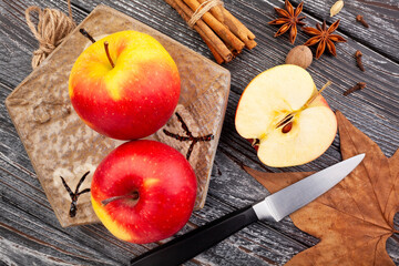 sliced colorful apples on wood background