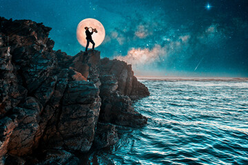 silhouette of a person playing saxophone on the top of the cliff with Full Moon background.