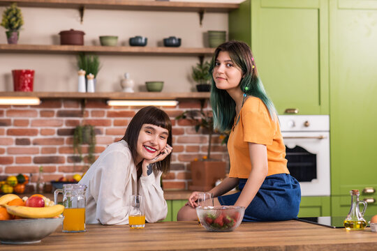 In the morning in the large kitchen island lesbian couple speeding time together while preparing the breakfast they discussing and smiling large concept of LGBT a freedom equality friendship