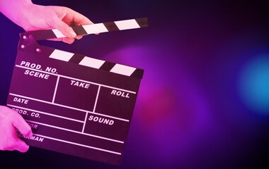 Classic movie slate or clapper board. Empty film making clapperboard on color background