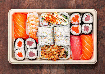 Sushi set with rice, salmon  and shrimps on wooden table, top view. Japan restaurant menu.