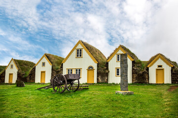 Fototapeta na wymiar Traditional Icelandic Turf Houses in West Iceland countryside, The picturesque village of old houses covered with turf and grass. The concept of cultural and historical tourism in Keldur 
