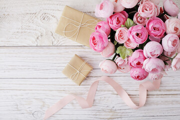 gift boxes with ribbon bow, flowers, white rustic wooden background. copy space. mothers day, birthday, wedding, sale concept