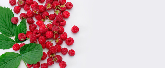 Ripe juicy fresh raspberries with green leaf on white background flat lay top view. Raspberry pattern. Organic raspberries, healthy food, vitamins, summer berry fruit background. Raspberry harvest
