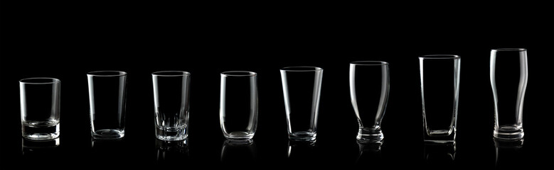 Set of empty glass of water isolated on black background
