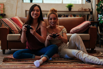 Multiracial couple playing video games in the living room