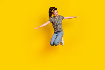 Fototapeta na wymiar Full length body size photo of jumping high female student gesturing arms flying isolated on bright color background