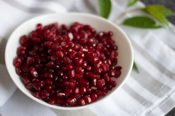 pomegranate seeds in bowl on table