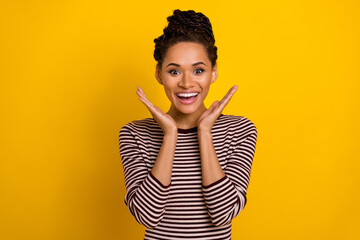Photo of astonished positive girl raise opened hands palms cant believe isolated on yellow color background