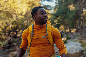 African American hiker hiking up river - Powered by Adobe