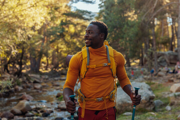 Cheerful hiker next to mountain stream