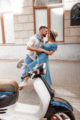 Naklejka na ściany i meble Happy beautiful couple kissing in european city in summer day