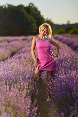 Woman in lavender field at sunset