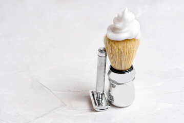 Fototapeta na wymiar Safety razor and a lathered shaving brush