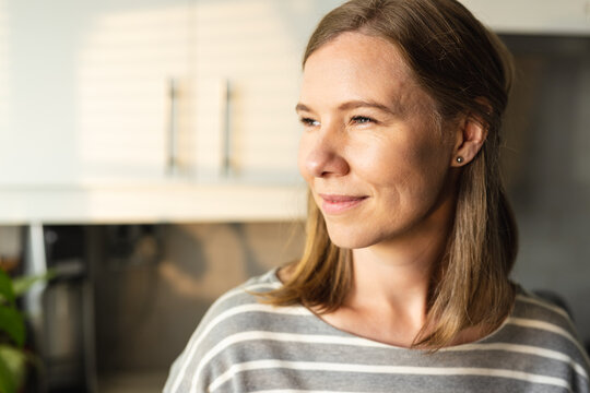 Close-up Of Mid Adult Caucasian Lesbian Woman Looking Away While Contemplating In Kitchen