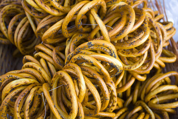 Tasty bagels on rope close up