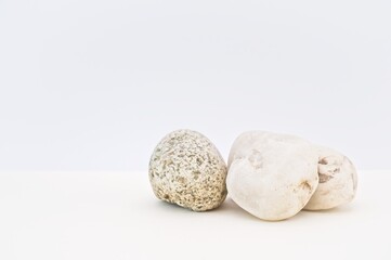 stones on a white desk with withe wall background