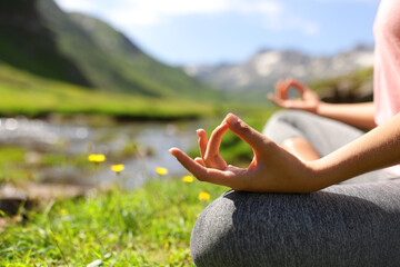 Close up of a woman hands doing yoga in nature