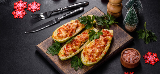 Baked stuffed zucchini boats with minced chicken mushrooms and vegetables with cheese. Christmas table