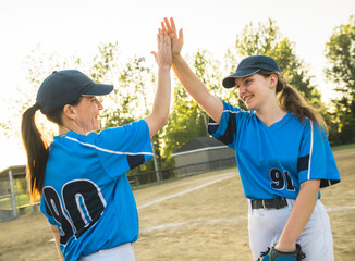 Group of baseball players standing together on the playground giving high five