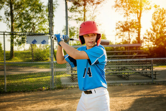 A children baseball players with bat on the playground