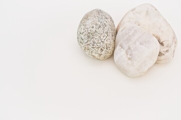 Fototapeta na wymiar stones on a white desk background with copy space