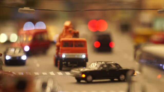 City traffic closeup static frame. Footage. Model of a city street with cars. The vehicle is stopped and the turn signal is flashing