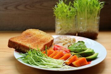 Delectable Fresh Water Spinach Microgreens and Avocado with Steamed Pumpkin Salad for Breakfast