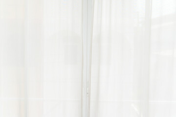 Backlit window with white curtains