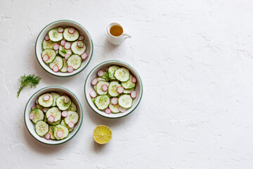 Radish and cucumber salad served in a three small round bowls