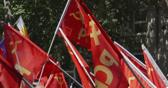 Spanish communist party flags waving at a protest
