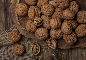 Walnuts on a dark wooden table, top view