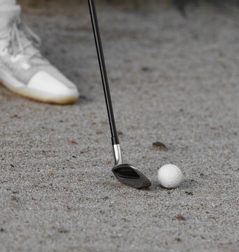 bunker shot, golfer hitting out of a trap