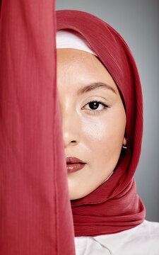 Closeup portrait of elegant muslim woman wearing a hijab, posing in studio. Half headshot of stunning confident arab model isolated against grey background. Zoomed in on fashionable middle eastern